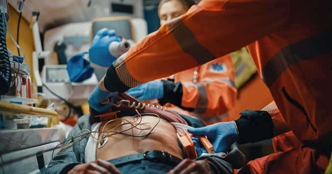 medics treat patient inside an ambulance