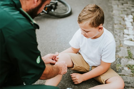 injured-boy-getting-help-from-paramedics@900x600