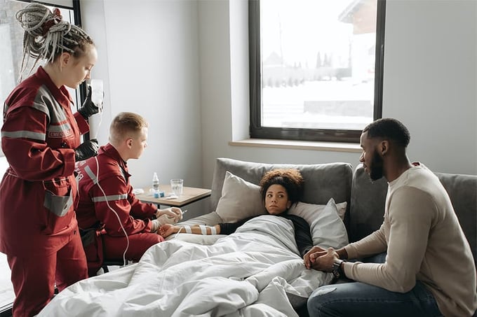 paramedics-sick-woman-and-husband@900x600