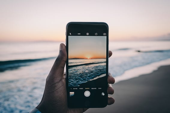 person-taking-picture-of-sunrise@900x600