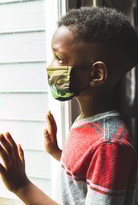boy-wearing-mask-looking-outside-400x600
