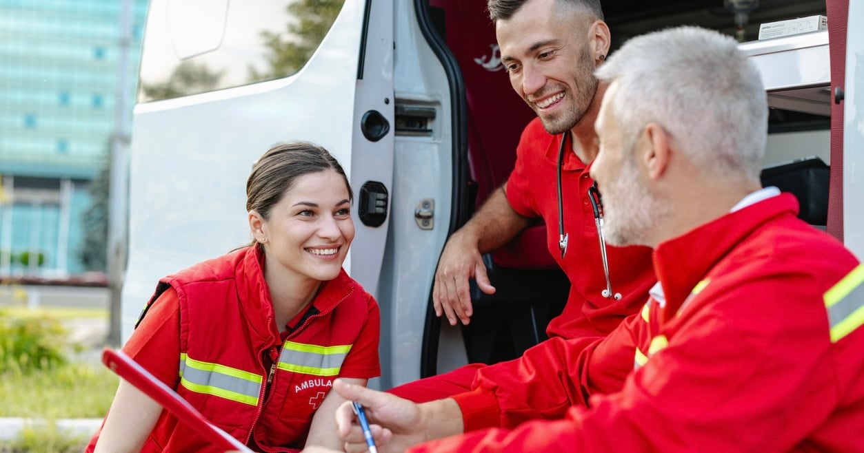 EMS crew smiling and talking with EMS leader