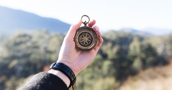 person-holding-compass-1200x630