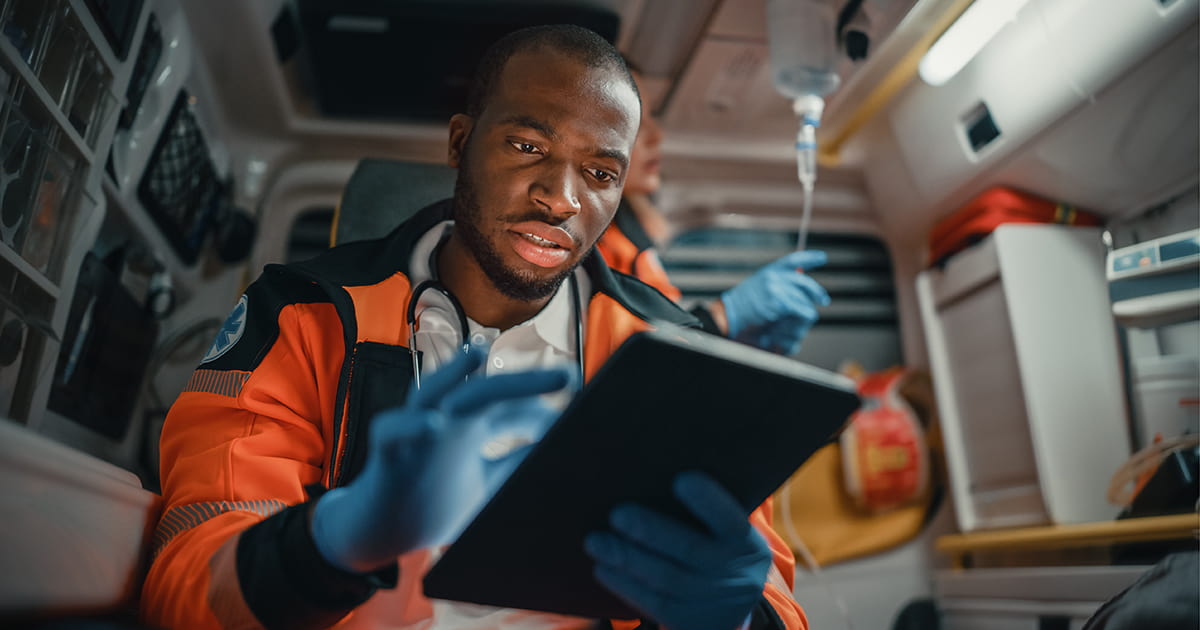 medic-in-ambulance-with-tablet