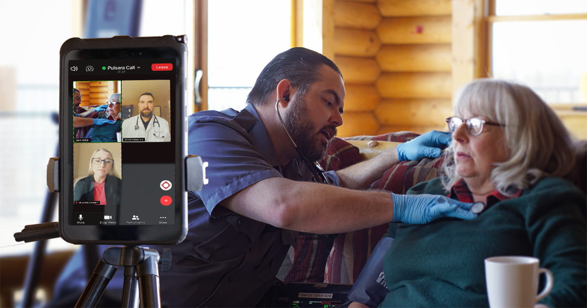 Doctors and a community paramedic examine a patient via telehealth