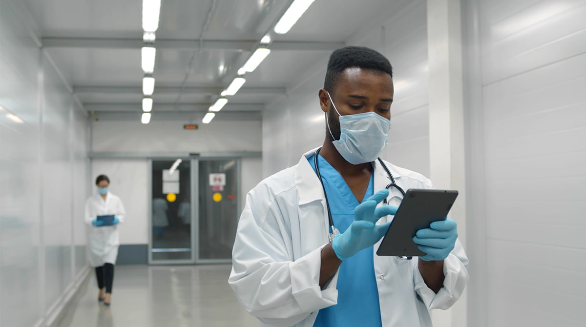 doctor using tablet in hospital hallway