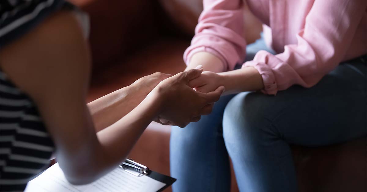 psychologist-holds-hands-of-female-patient