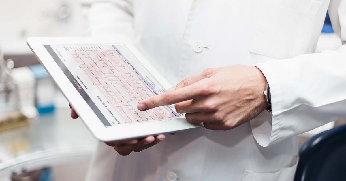 doctor looking at patient's ecg on tablet