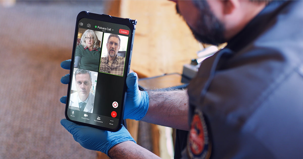 paramedic-holding-phone-telehealth-call