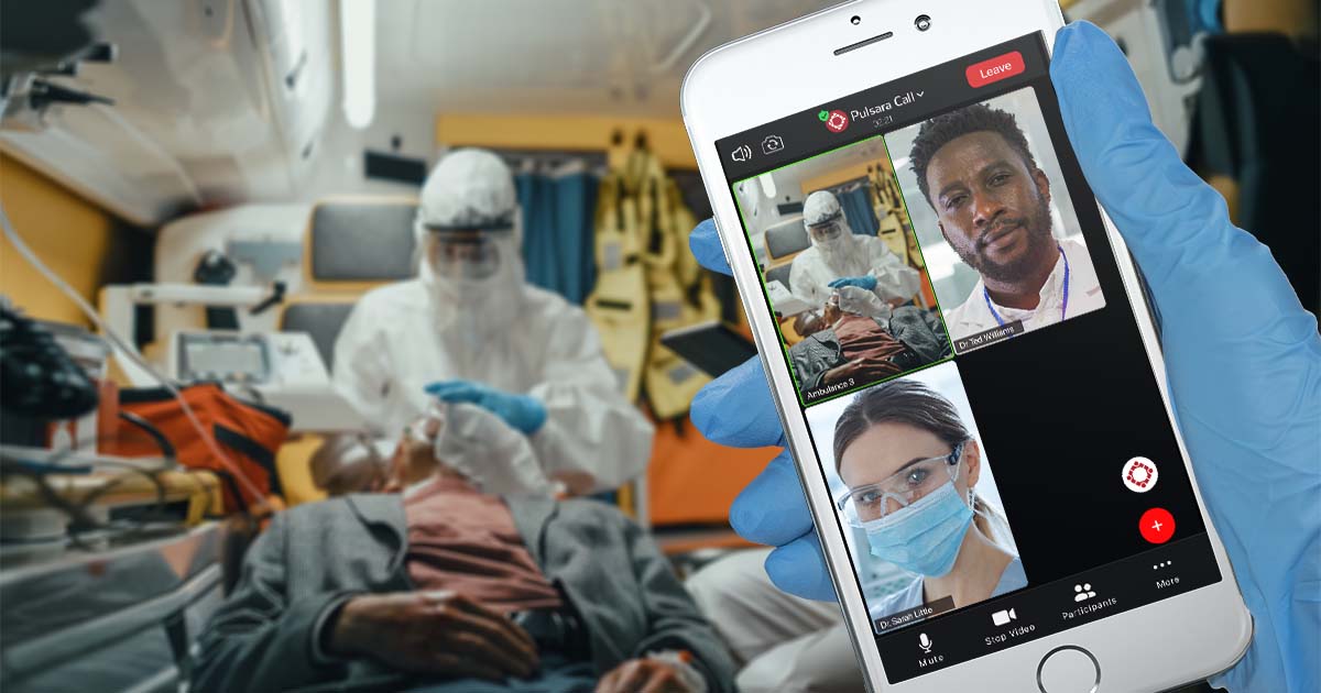 Medics treat a patient in the ambulance, doing video call with doctors using Pulsara