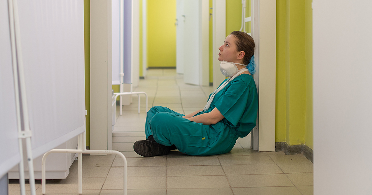 tired-nurse-sitting-on-floor
