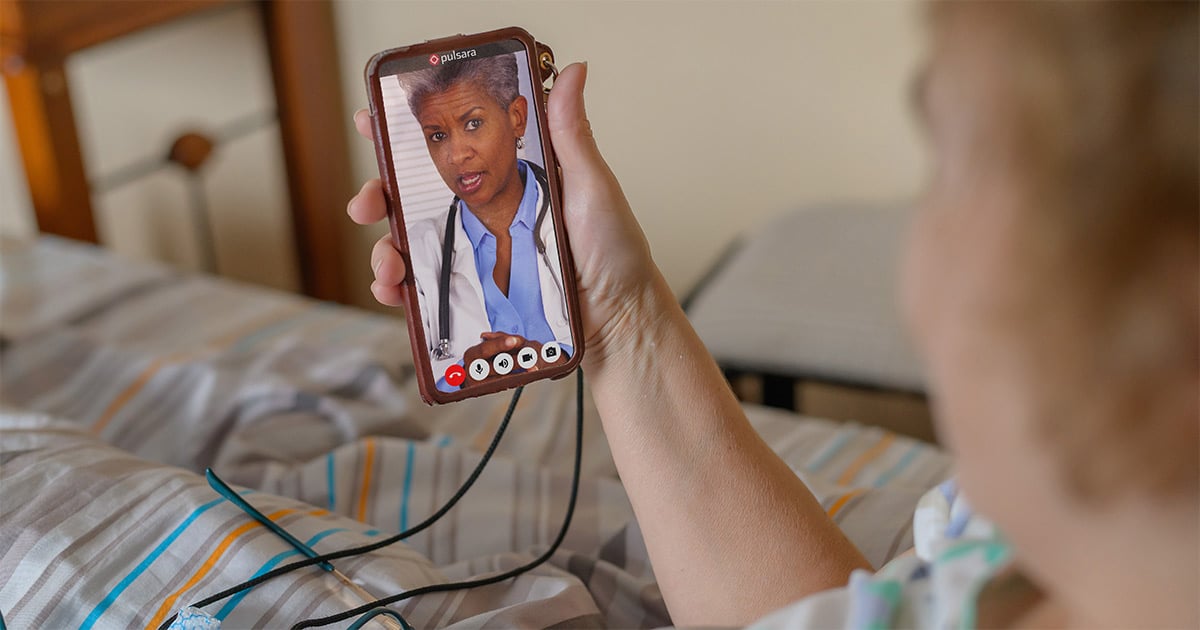 patient-in-bed-telehealth-call